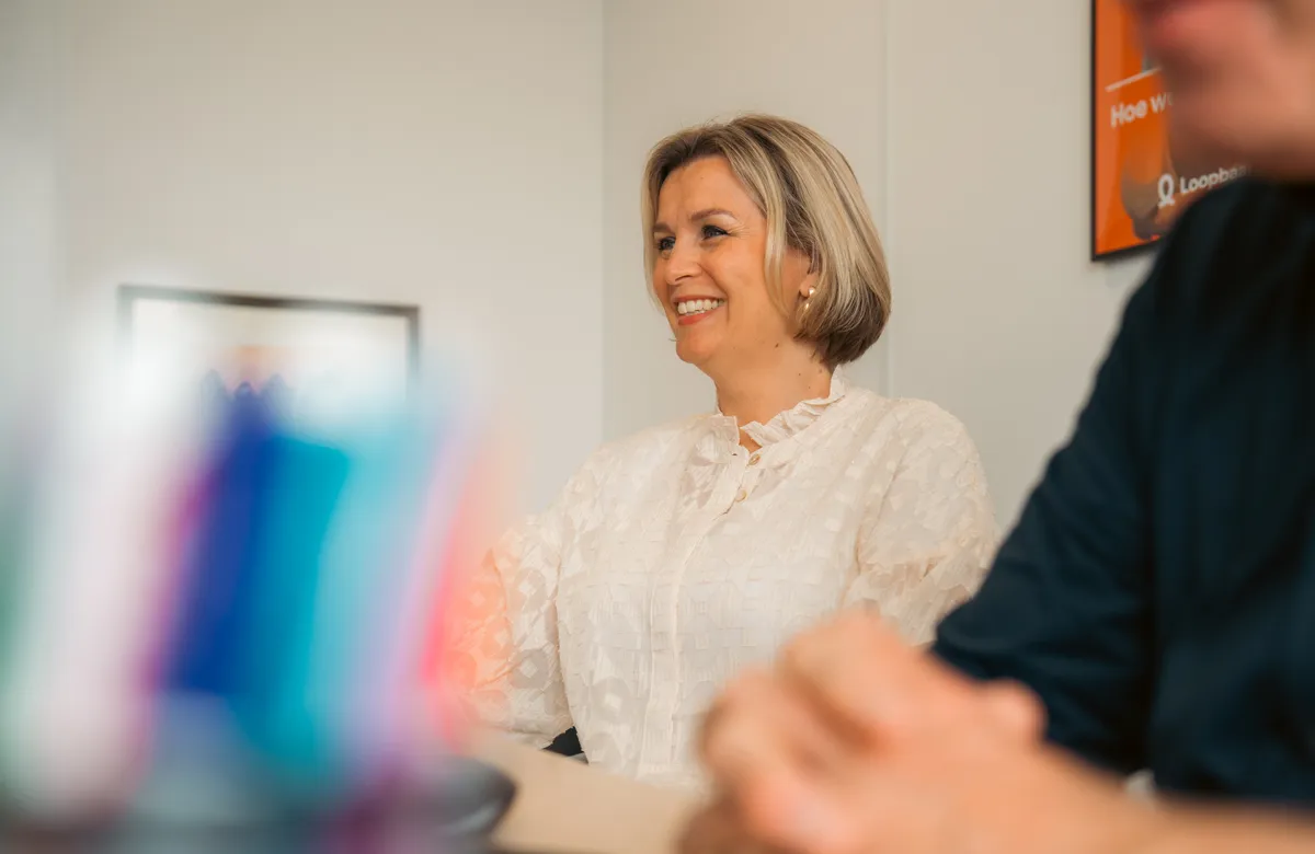 Lachende vrouw in teamsetting